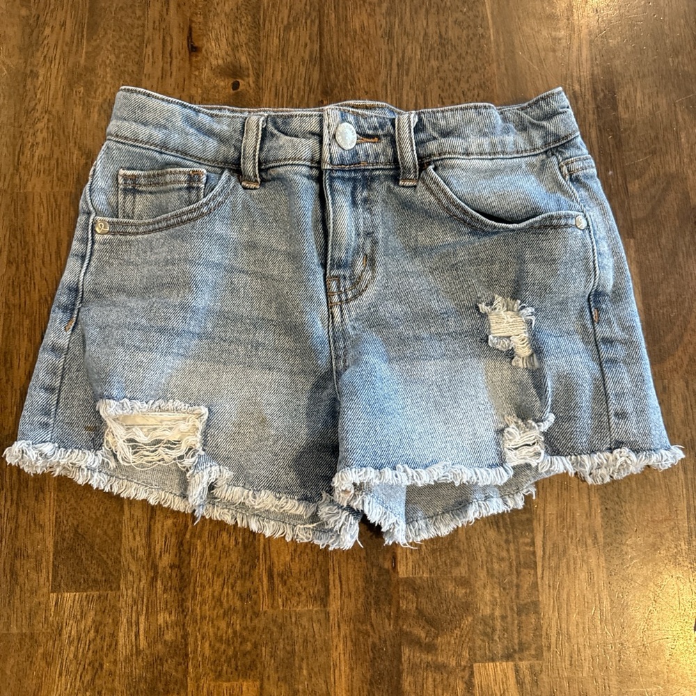 New without tags, Light wash blue denim shorts with distressed details, Size L